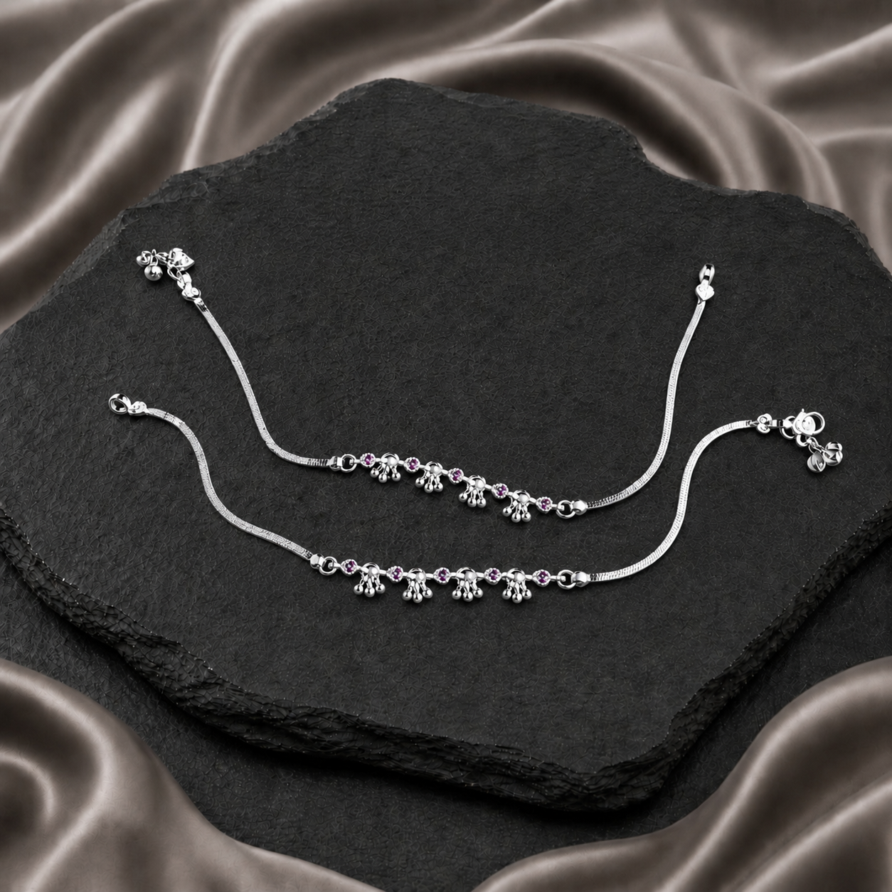 Pair of silver payals with pink stones and clustered bell charms
