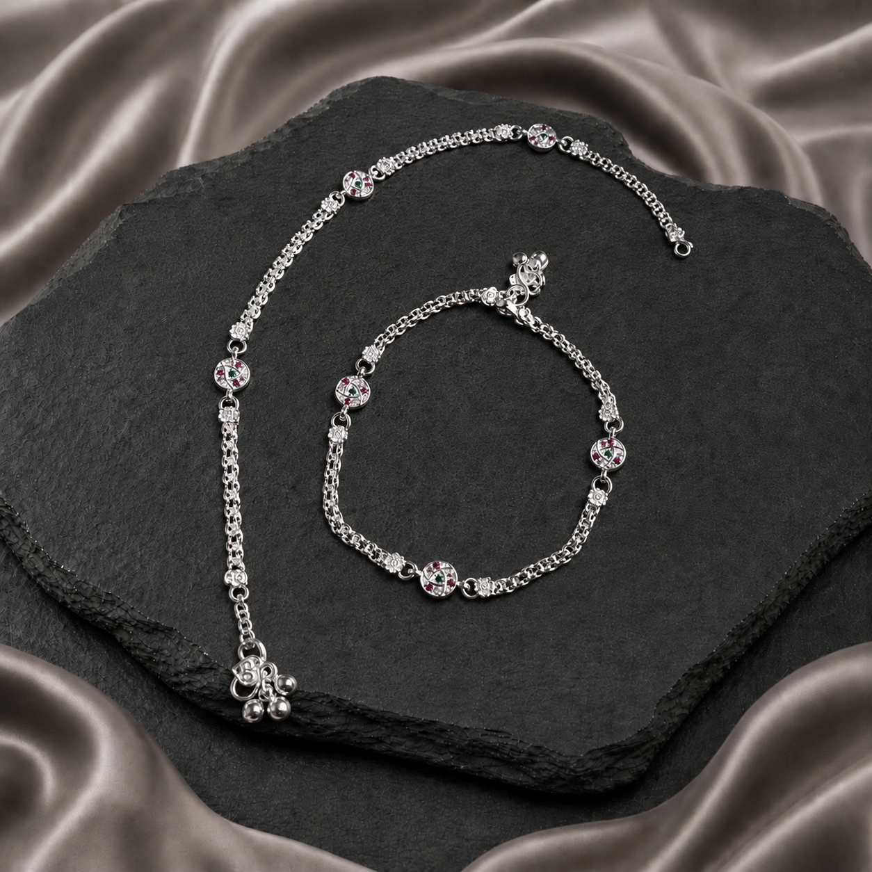 Pair of silver chain payals with round pink and green stone details